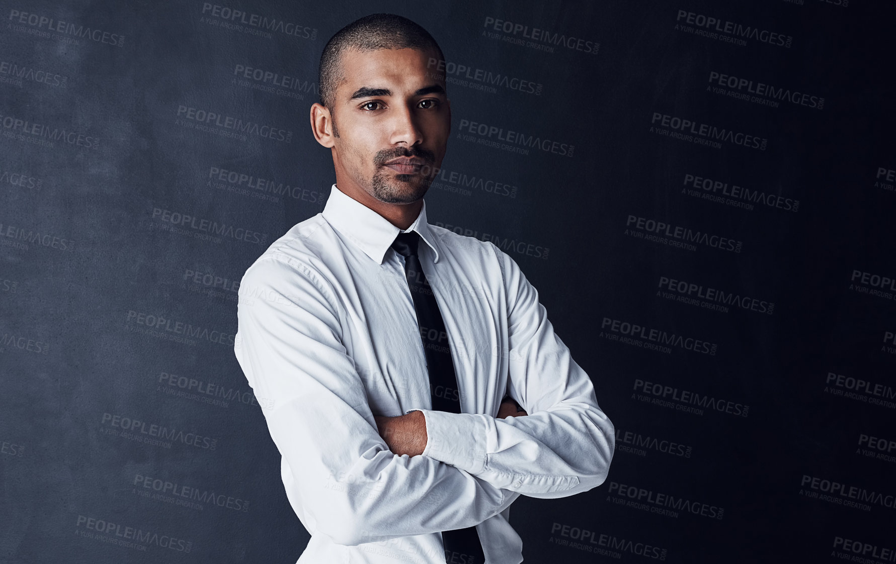 Buy stock photo Studio portrait of a confident young businessman against a dark background