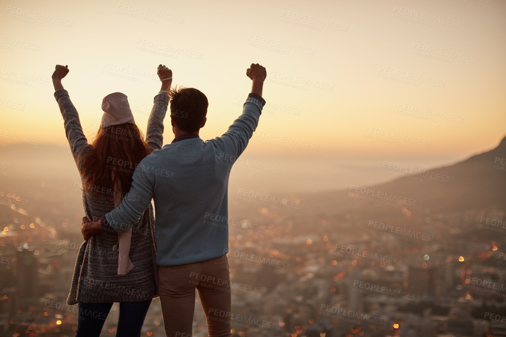 Buy stock photo Rearview shot of an affectionate  young couple admiring a city view at dawn