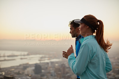 Buy stock photo Shot of an athletic young couple out for a run in the morning