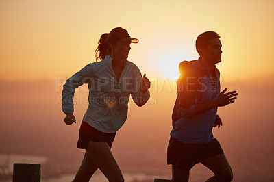 Buy stock photo Sunrise, couple and running with silhouette for training, exercise and fitness with cardio for health. Wellness, sport and athlete with runner partner with city view in the morning with sprint