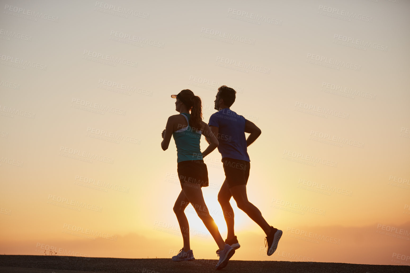 Buy stock photo Couple, running and sunrise fitness in outdoor, together and cardio challenge or marathon training. People, action and bonding together on jog in nature, performance and sports workout or practice