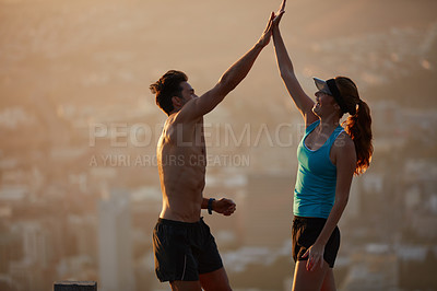 Buy stock photo Shot of an athletic young couple out for a run in the morning