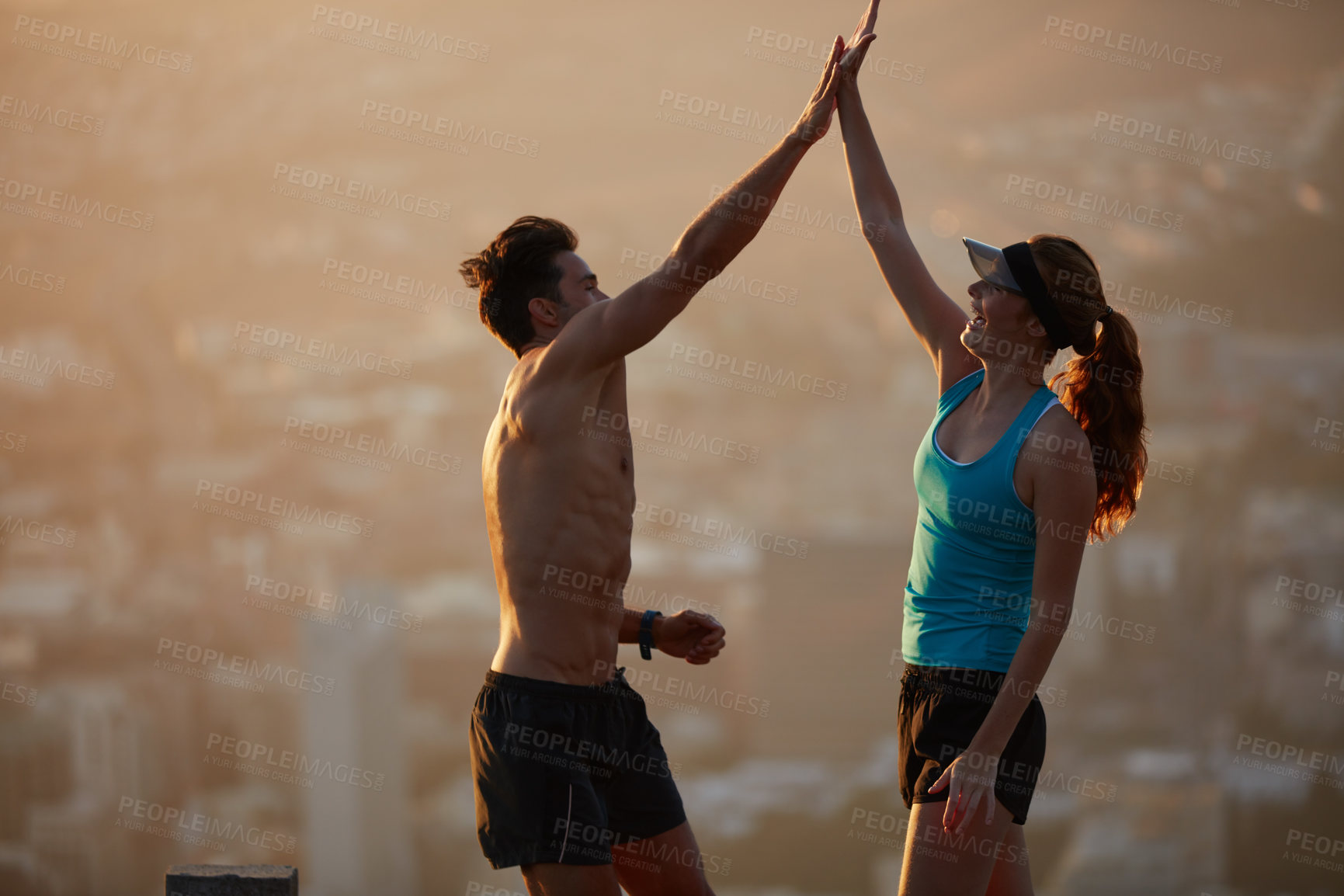 Buy stock photo Shot of an athletic young couple out for a run in the morning