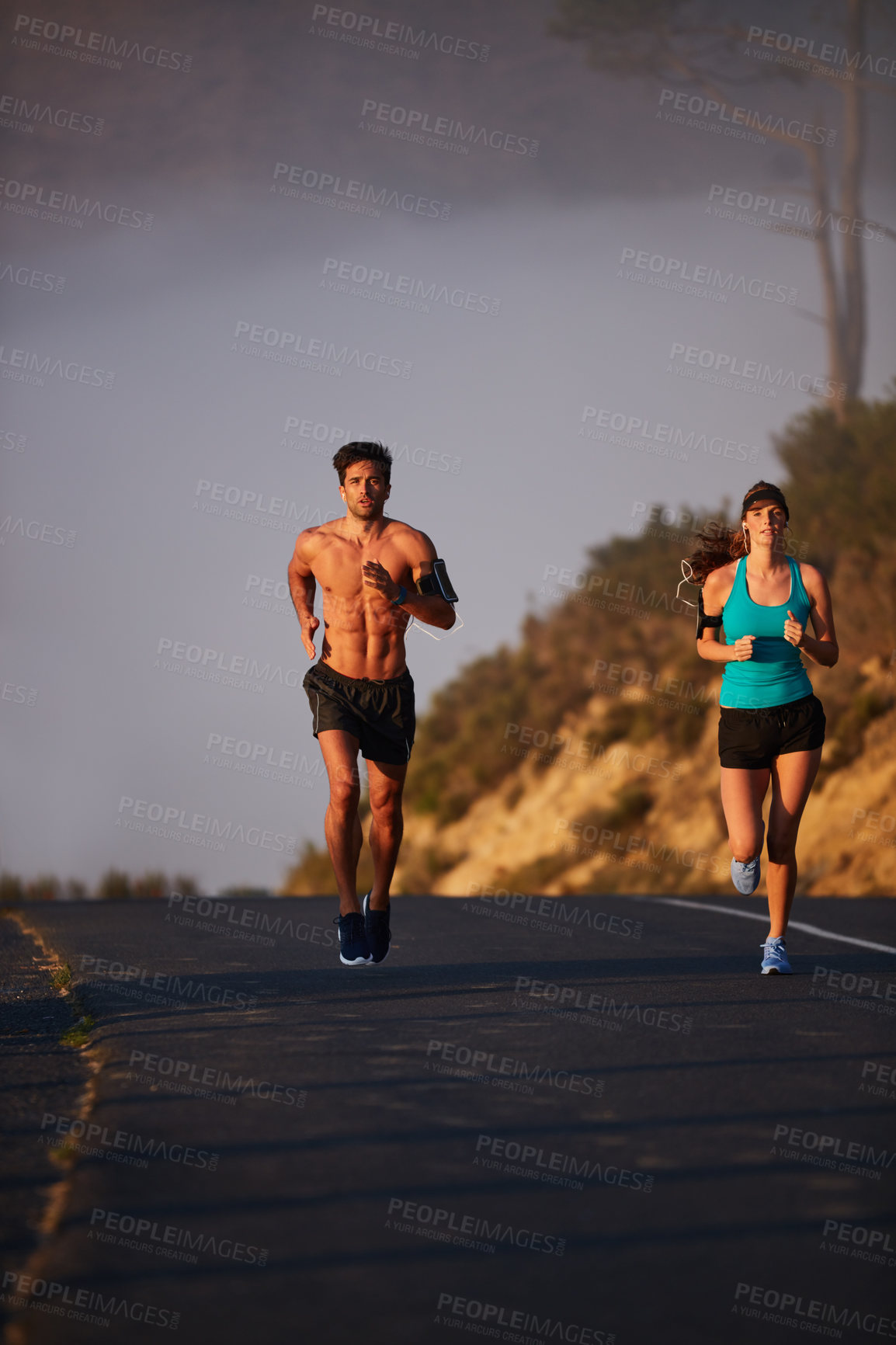 Buy stock photo Shot of an athletic young couple out for a run in the morning