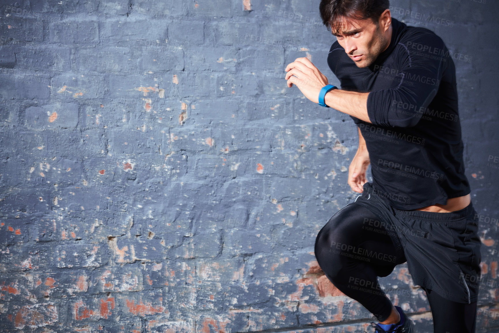 Buy stock photo Athlete, man and running outdoor by wall with wellness, cardio and workout for endurance training. Space, active person or fast runner with sprint for race preparation, performance or speed exercise.