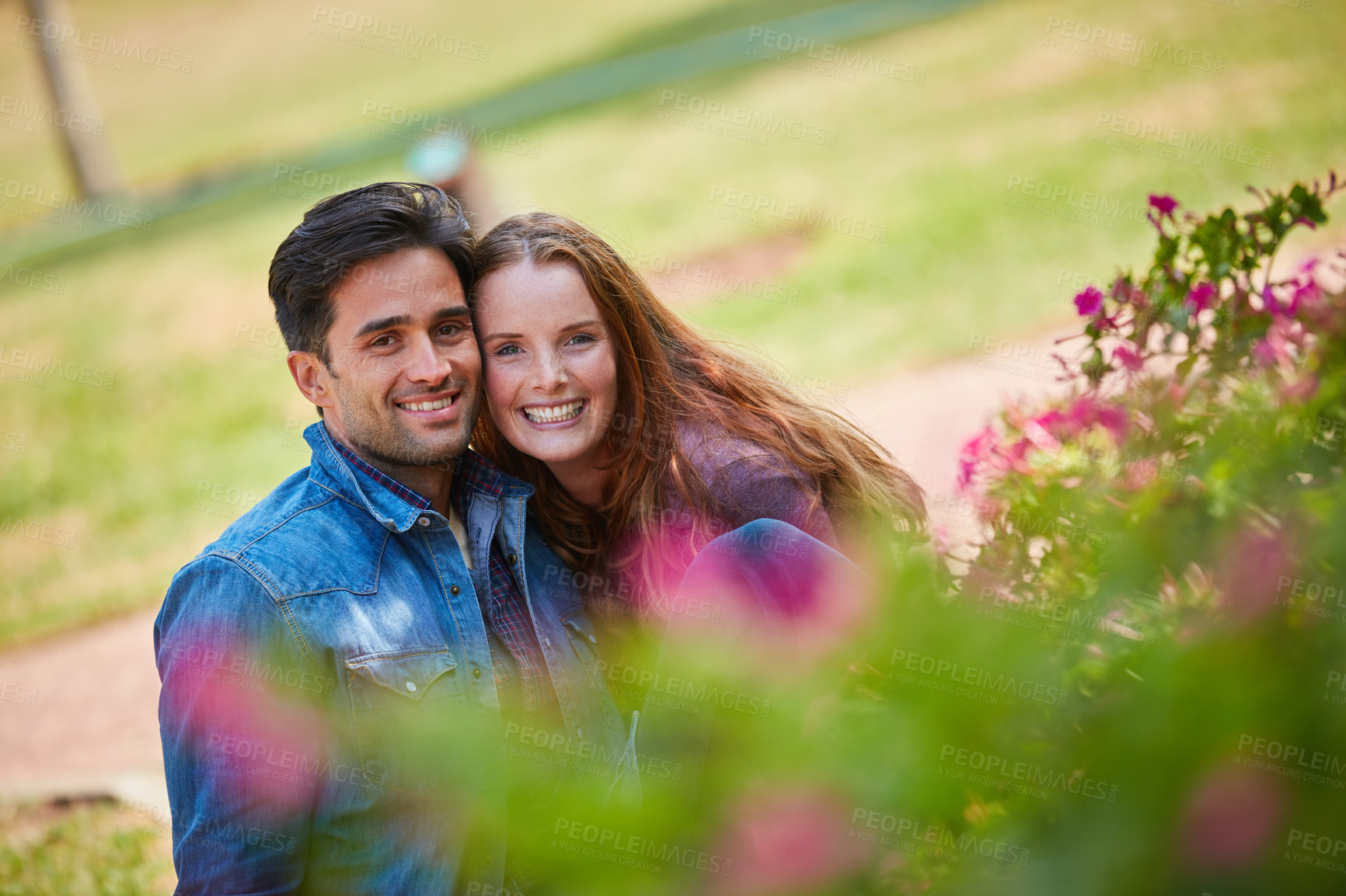 Buy stock photo Shot of a smiling young couple enjoying the day together at the park