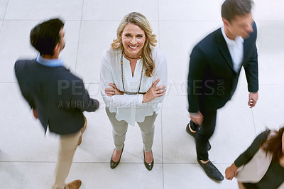 Buy stock photo Portrait of a businesswoman standing in a busy office