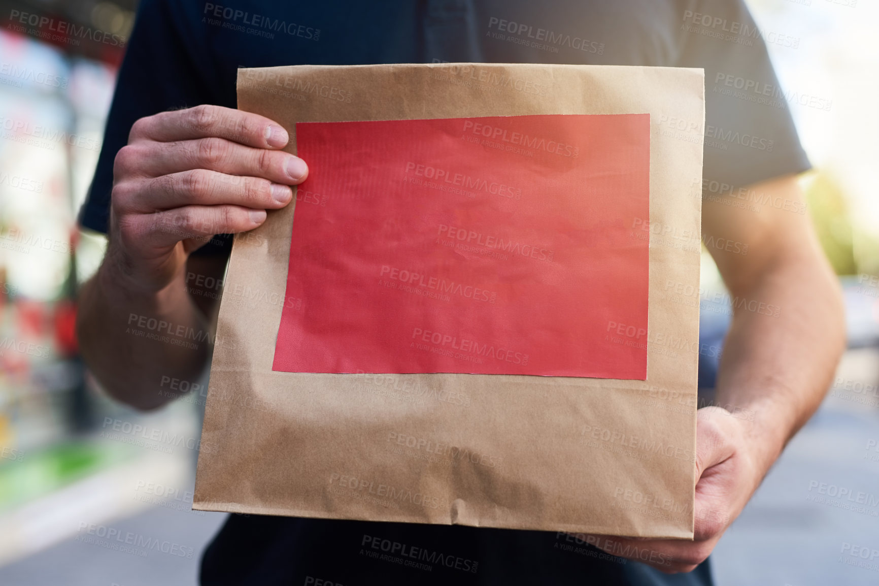 Buy stock photo Cropped shot of a man holding a paper bag for delivery