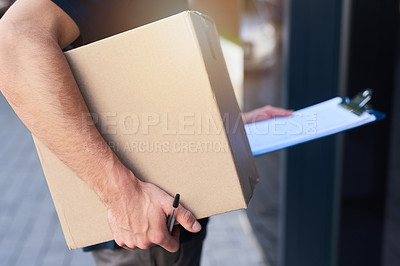 Buy stock photo Cropped shot of a courier holding a box for delivery