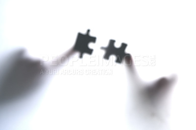Buy stock photo Cropped shot of two unrecognizable people holding two puzzle pieces together