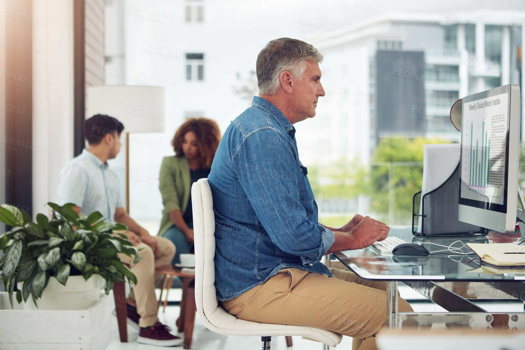 Buy stock photo Cropped shot of a mature businessman working on his designs in the office