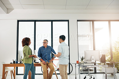 Buy stock photo Cropped shot of three creative professionals talking in the office