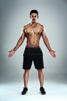 Buy stock photo Full length portrait of a sporty young man standing against a grey background