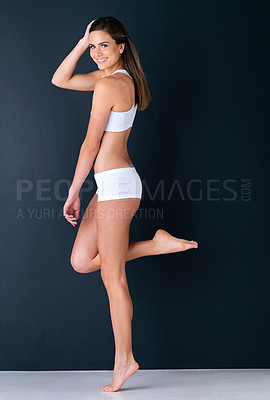 Buy stock photo Studio portrait of a healthy-looking young woman against a dark background