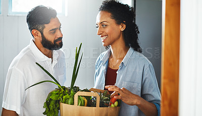 Buy stock photo Shot of a happy person holding a shopping bag full of healthy vegetables