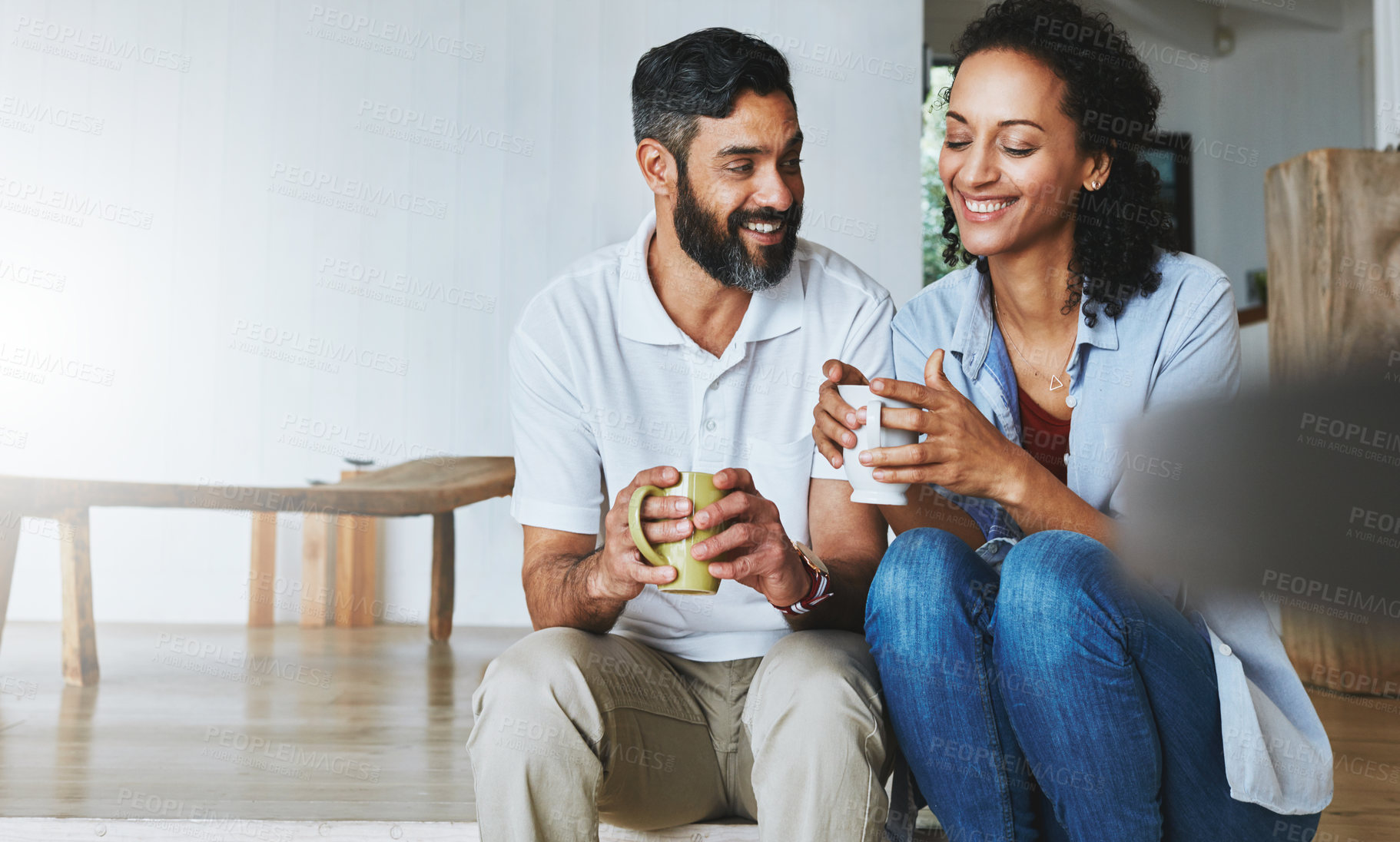 Buy stock photo Couple, home and coffee for relax on floor, calm and morning smile in living room. Love, house and laugh for man and female person in step, together and support or unity with tea or drink in lounge