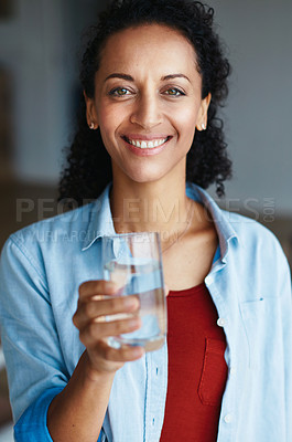 Buy stock photo Portrait of a woman drinking a glass of water at home