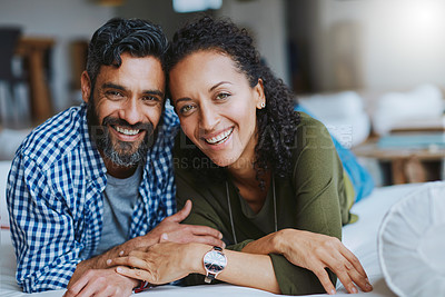 Buy stock photo Portrait of a happy laid-back couple relaxing together at home