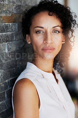 Buy stock photo Portrait of a serious woman posing against a brick wall at home