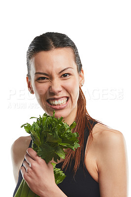 Buy stock photo Studio portrait of an attractive young woman posing with celery against a white background