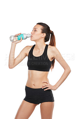 Buy stock photo Cropped shot of a young female athlete drinking water against a white background