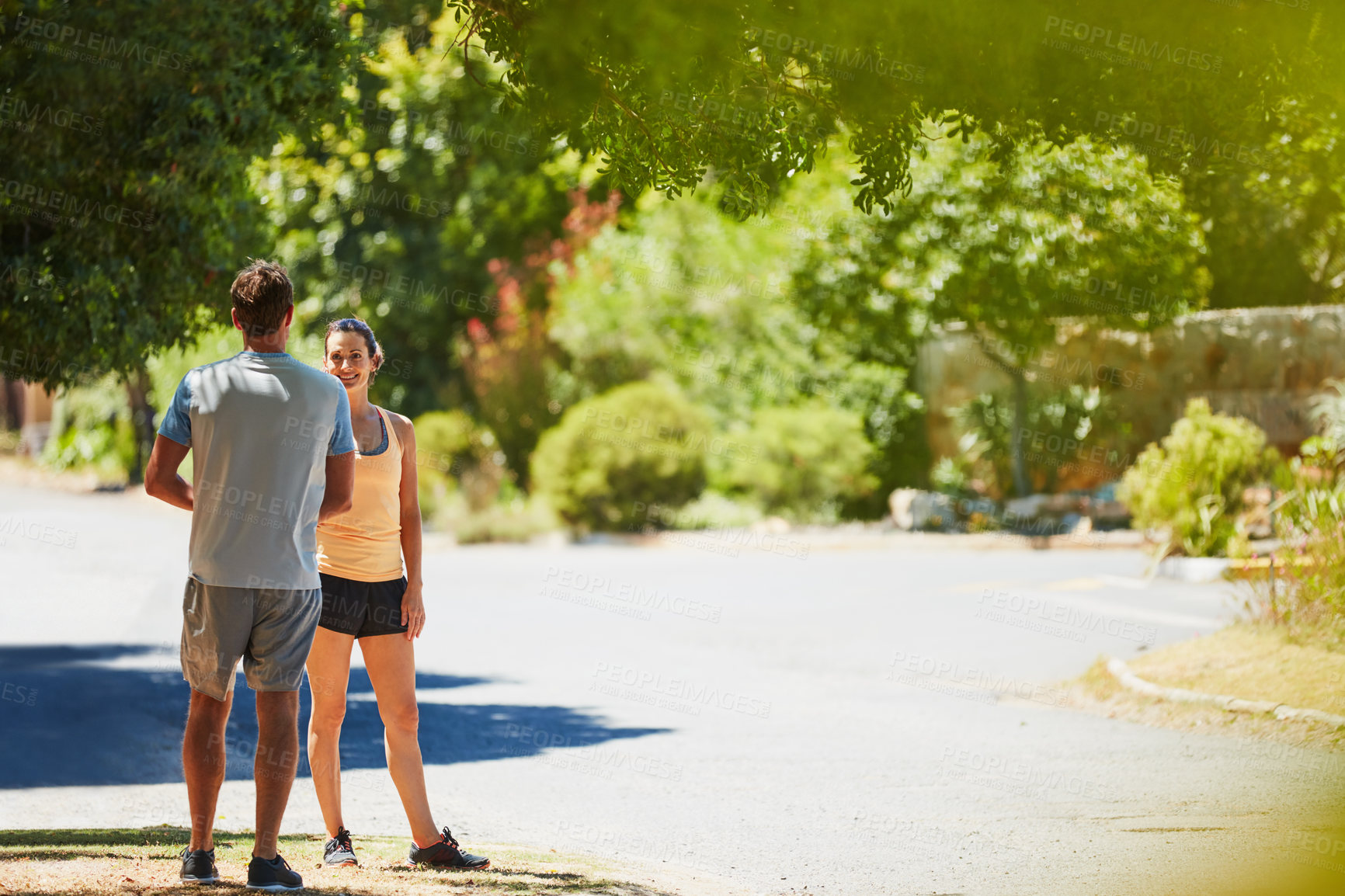 Buy stock photo Shot of a happy couple jogging together in their neighborhood