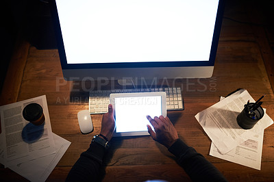 Buy stock photo High angle shot of an unrecognizable man working on his tablet in the office