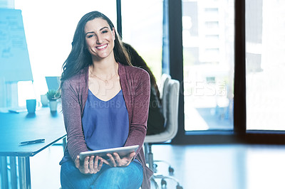 Buy stock photo Shot of a businesswoman using a digital tablet while sitting in an office