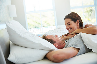 Buy stock photo Shot of a mature couple relaxing together in bed