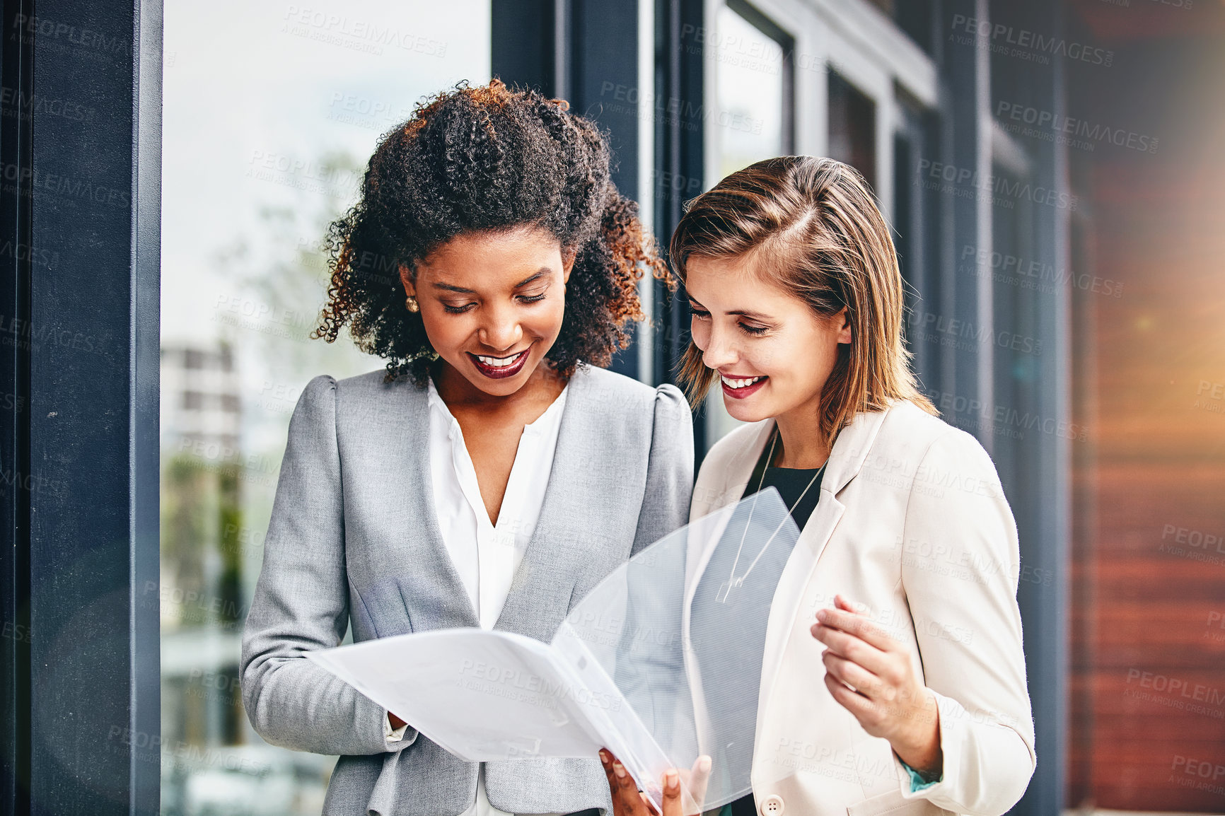 Buy stock photo Cropped shot of two businesswomen having a discussion outside an office