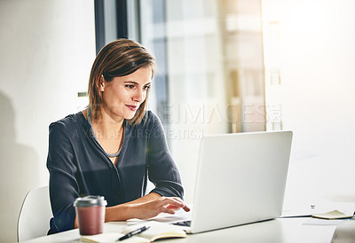 Buy stock photo Cropped shot of a young businesswoman working on a laptop in an office