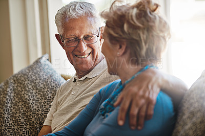 Buy stock photo Shot of a senior couple relaxing together on the sofa at home