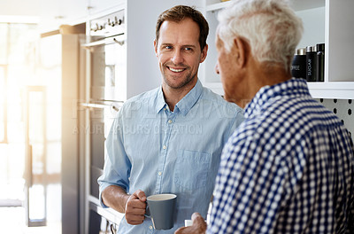 Buy stock photo Cropped shot of a man and his elderly father drinking coffee together at home