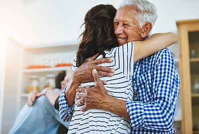 Buy stock photo Cropped shot of a woman hugging her elderly father at home