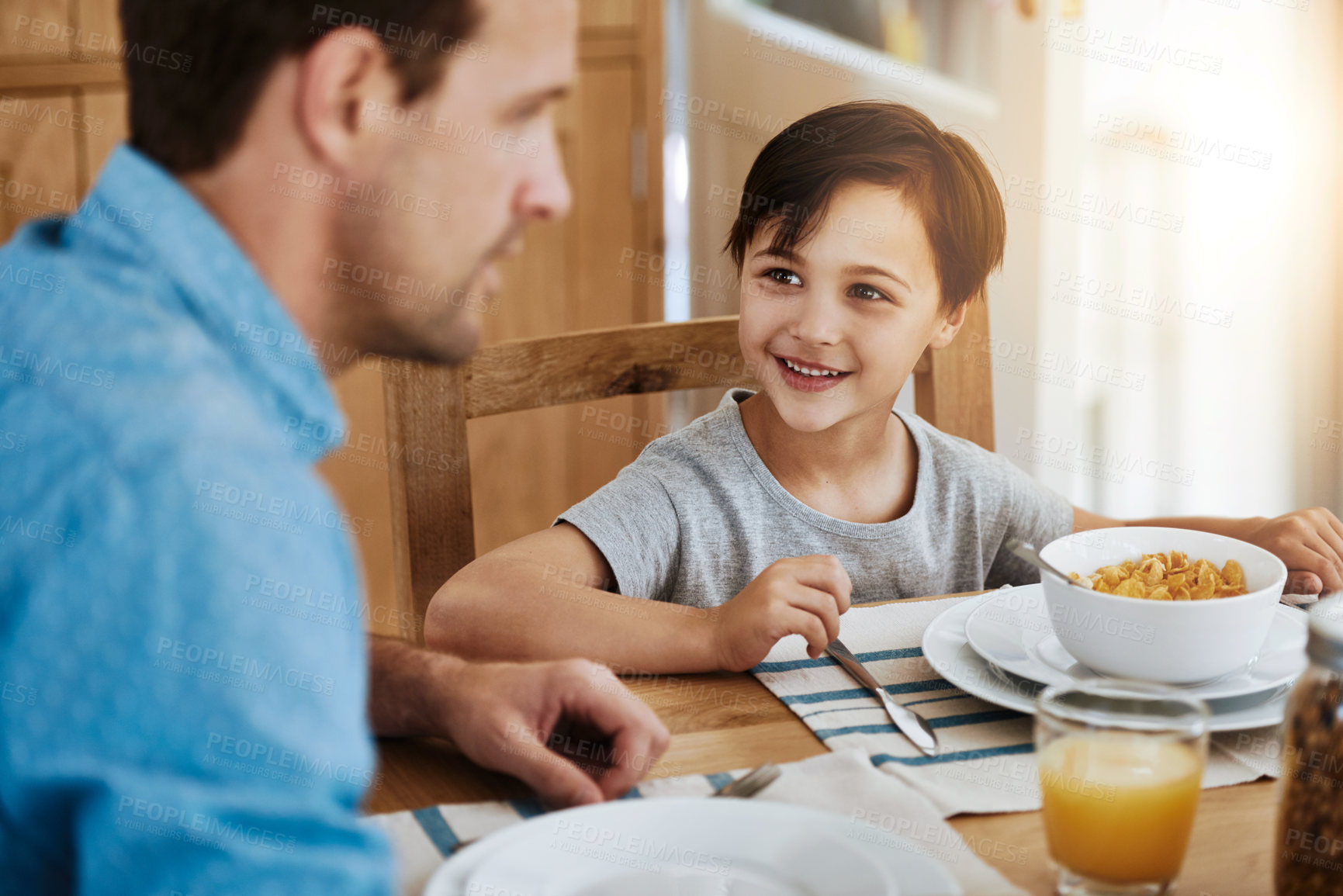 Buy stock photo Cropped shot of a father and his little son having breakfast together at home