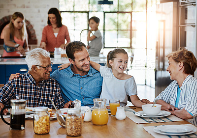 Buy stock photo Cropped shot of a multi generational family enjoying breakfast together at home