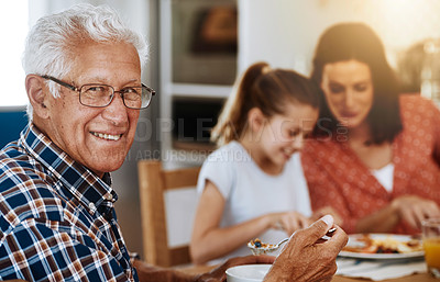 Buy stock photo Portrait of an elderly man enjoying breakfast with his family at home