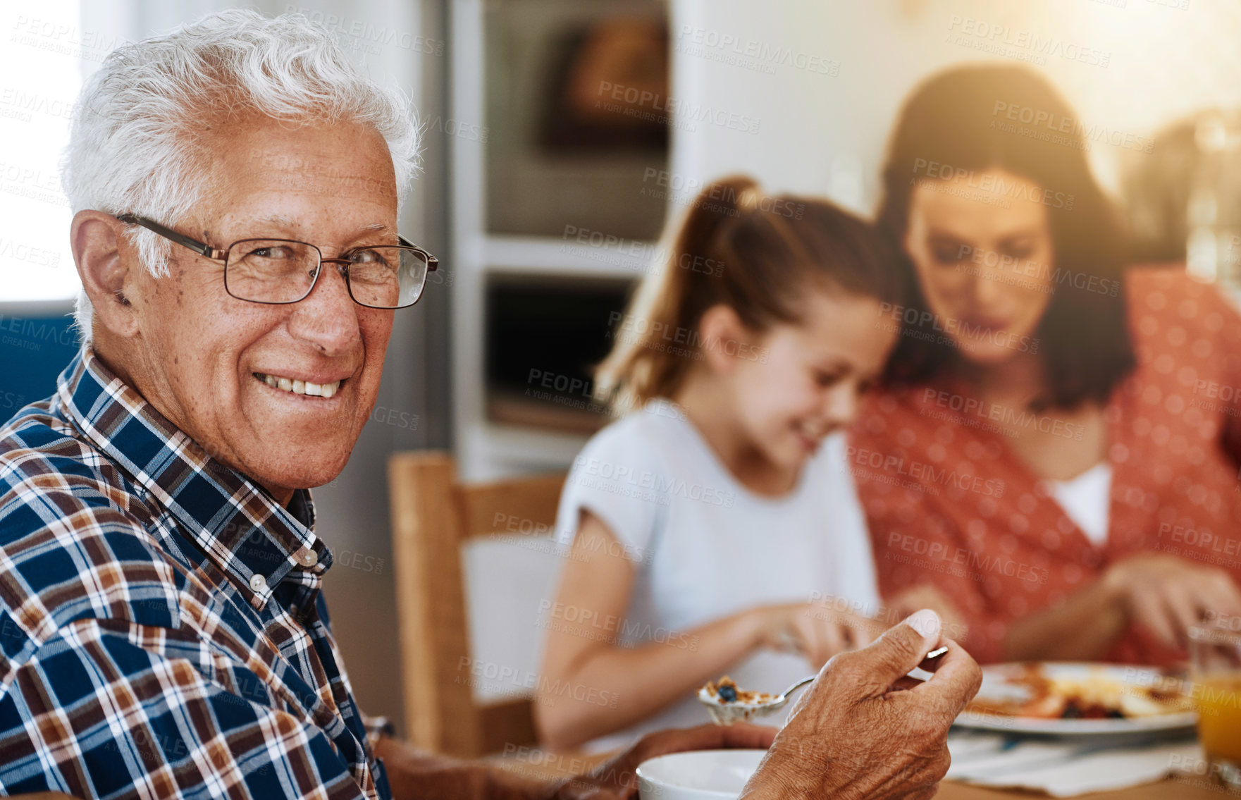 Buy stock photo Portrait of an elderly man enjoying breakfast with his family at home