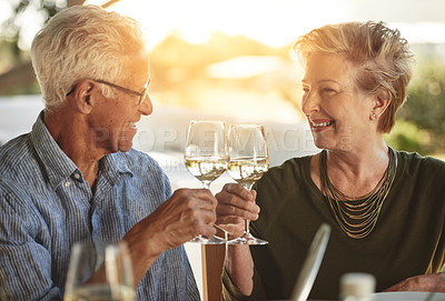 Buy stock photo Shot of a happy mature couple enjoying lunch together outside