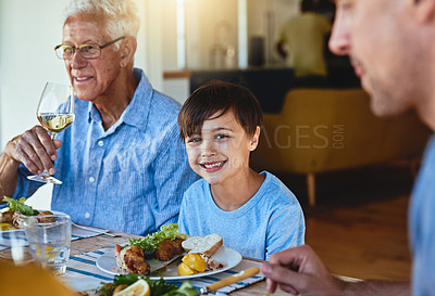Buy stock photo Shot of a happy family enjoying lunch together around a table outside