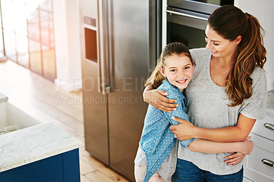 Buy stock photo Portrait of a happy mother and daughter in a loving embrace at home