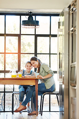 Buy stock photo Portrait of a happy mother and daughter enjoying breakfast together at home