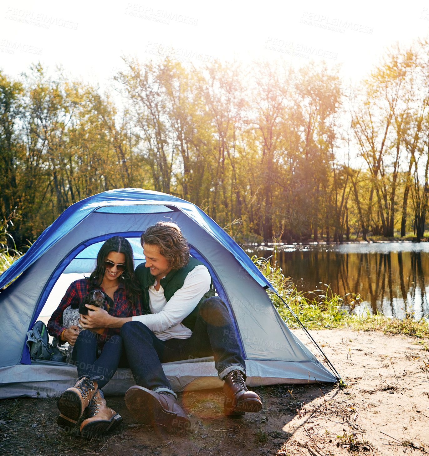 Buy stock photo Shot of an adventurous couple out camping with their dog