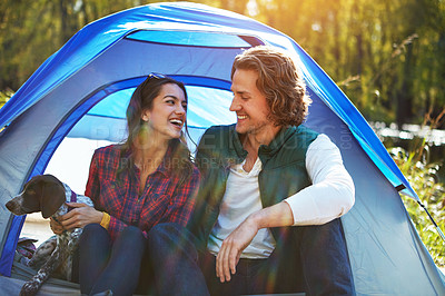 Buy stock photo Shot of an adventurous couple out camping with their dog