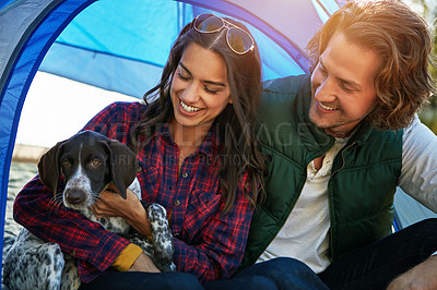 Buy stock photo Shot of an adventurous couple out camping with their dog