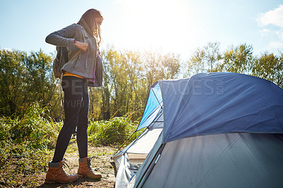 Buy stock photo Cropped shot of an attractive young woman sitting at her campsite