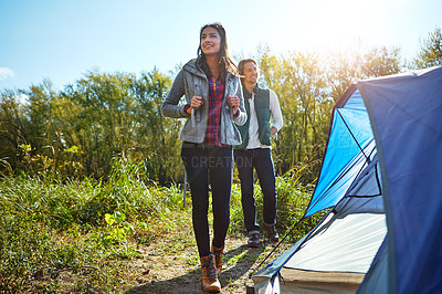 Buy stock photo Shot of an adventurous young couple at their campsite