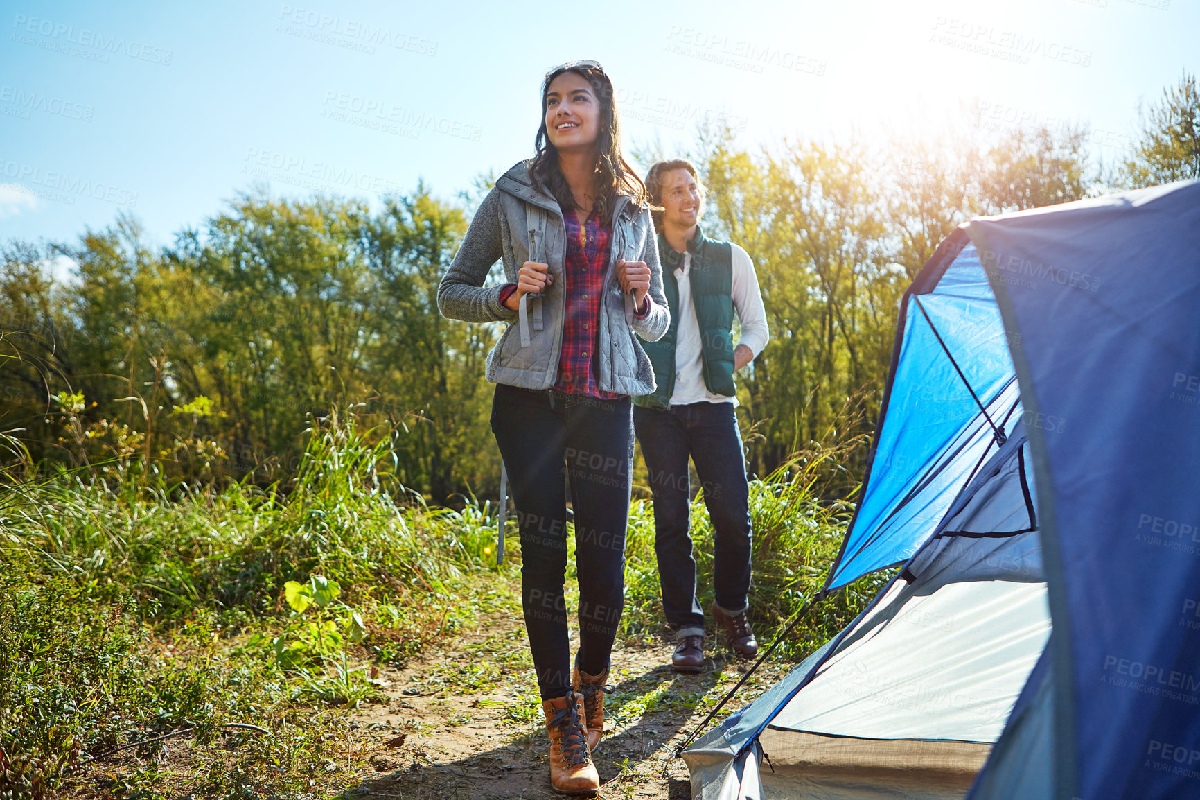 Buy stock photo Thinking, couple and happy at campsite outdoor for travel, trekking adventure and holiday trip. Below, people and backpacking with tent shelter, nature view and camping together for vacation getaway