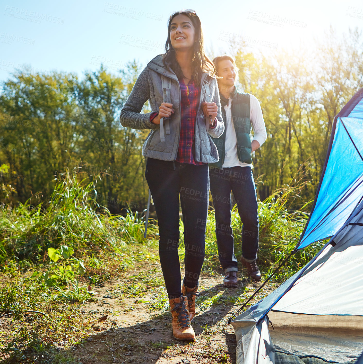 Buy stock photo Shot of an adventurous young couple at their campsite