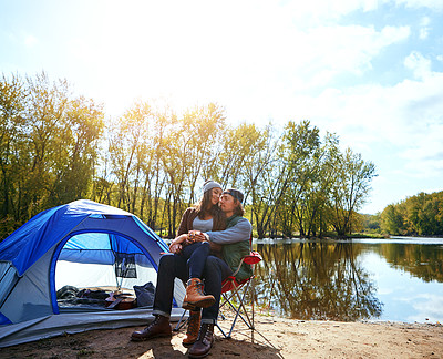 Buy stock photo Shot of an adventurous young couple at their campsite